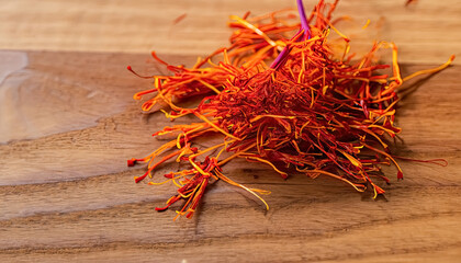 Saffron on Wooden Table - A Highly Prized Spice for Culinary and Medicinal Use, Savoring the Exotic Aroma and Taste of Saffron on Wooden Table, The Golden Spice: Saffron with copy space 