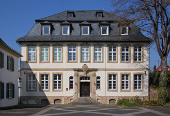 Facade of a former neo-baroque school building with mansard roof in the old town of Bad Sobernheim...
