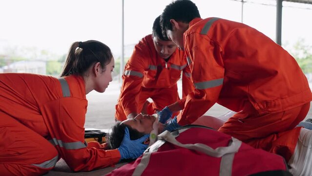 Group of Asian emergency medical technician (EMT) or paramedic team is holding manual stabilization of the head patients and wearing neck collar, Emergency medical services (EMS) nurses concept