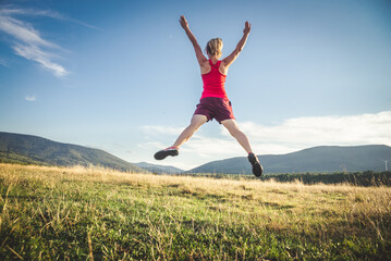 Fototapeta premium Young woman on the top of mountain
