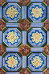 Rows of antique nyonya tiles with flowers with purple background. Vintage wall tile in penang.