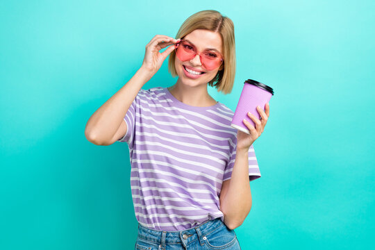 Photo of good mood funny person bob hairdo trendy t-shirt hold takeout cup touching eyewear isolated on turquoise color background