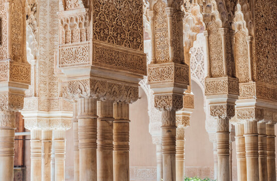 Court of the Lions surrounding with arches and columns decorated incredible details of stucco yeseria decoration, with sebka motif, arabesques, and muqarnas sculpting - art of Moorish architecture.