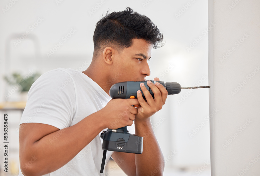 Poster This is where I need the hole. Shot of a man using a cordless drill on a wall.