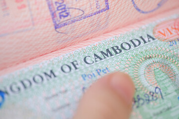 close-up part of page of document, foreign passport for travel with Cambodia visa, tourist visa...