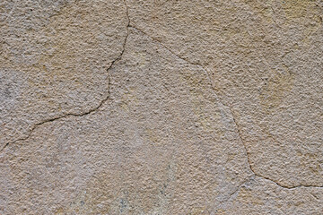 A fragment of a wall with cracks. Texture, wall background