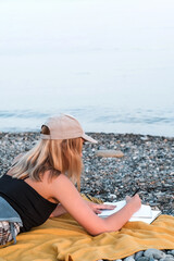 Travel. Staycation.local travel new normal.Girl at the seaside is dreaming and planning a trip, travel, tourism, vacation, relocation. Mental health and vacation travel