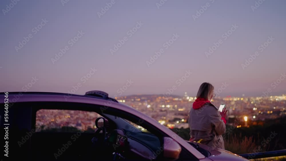 Poster caucasian female blogger browsing social media web while using cellular phone at evening near electr