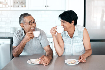 We love drinking our morning coffee together. Shot of a senior couple drinking coffee together at home.