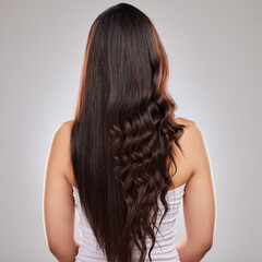 New hair means new horizons. Shot of a woman posing with half straightened and half curled hair.