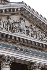 Fototapeta premium Architectural fragment of Brussels Stock Exchange building (BeursBourse) on the Place de la Bourse. The building erected from 1868 to 1873 in the Neo-Renaissance style. Brussels, Belgium.
