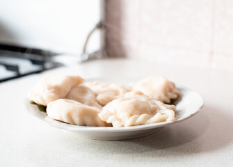 Vareniks on the plate , hot delicious vareniki, Ukrainian national cuisine, horizontal food photo