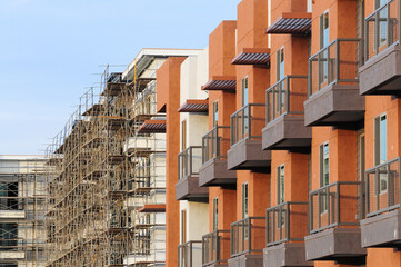 Exterior view of top stories of new apartment buildings at different stages of construction