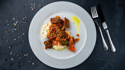 Beef goulash with carrots, tomatoes, onions with mashed potatoes.
