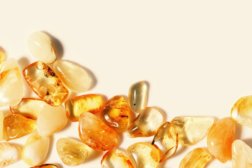 Natural gemstone amber texture beige monochrome background with copy space, light and dark stones...
