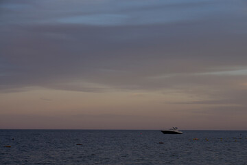 Fototapeta na wymiar Lonely boat at the sea during the sunset. 