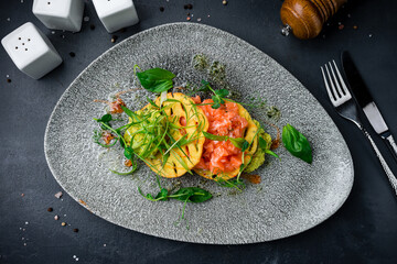 Fresh breakfast salmon pieces with cheese tortillas, avocado puree and herbs.