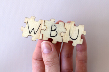 The acronym WBU, which stands for What About You. The letters written on the puzzles.