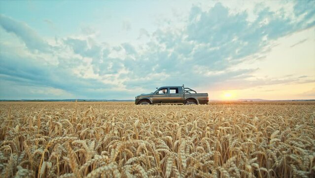 Soldier get out of the car near in a wheat field, dressed in camouflage. Blue sky. Brave man. War. Military concept. Slow motion