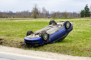 Obraz na płótnie Canvas Car accident scene, a passenger car left the road and overturned upside, car rollover