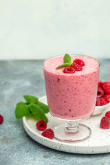 Yogurt smoothie with raspberries in glass on white marble table. weight loss concept. vertical image. place for text