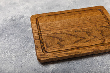 Fototapeta premium Cutting board on a textured marble kitchen table. Menu food card or recipes background concept.MOCKUP. Design. Place for text, copy space. The concept of food and cooking.