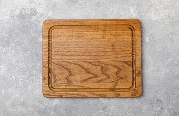 Cutting board on a textured marble kitchen table. Menu food card or recipes background concept.MOCKUP. Design. Place for text, copy space. The concept of food and cooking.