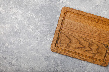 Cutting board on a textured marble kitchen table. Menu food card or recipes background concept.MOCKUP. Design. Place for text, copy space. The concept of food and cooking.
