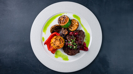 Beef fillet steak with zucchini, mushrooms, sweet peppers, grilled corn and berry sauce.