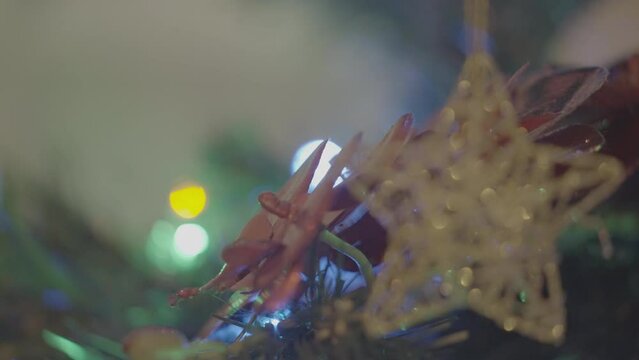 Christmas handmade toys and colored garlands on an artificial Christmas tree close-up. Removed from Apple ProRes S-log3 profile