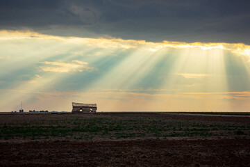 Fototapeta premium Sunbeams Shine on Abandoned Building in Rural Farmland