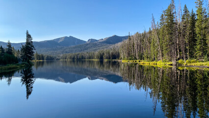 Sylvan Lake morning reflections of the trees and mountains in Yellowstone National Park