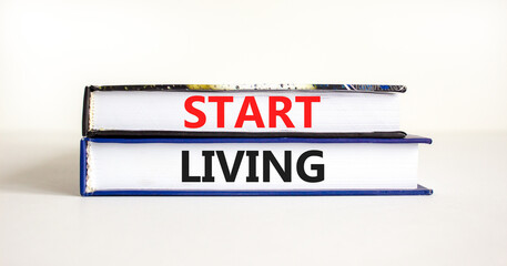 Start living symbol. Concept words Start living on beautiful books. Beautiful white table white background. Business and Start living concept. Copy space.