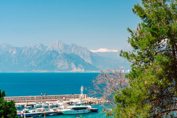 Fototapeta premium Aerial view of the port and the lighthouse in the Turkish city of Antalya. View of the port from Kaleici in Antalya.