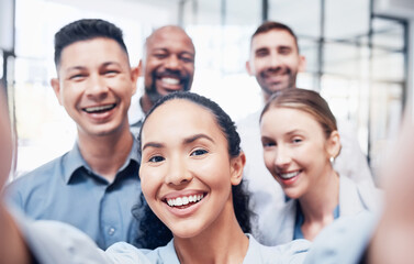 Nothing wrong with a quick selfie. Shot of a group of businesspeople taking a selfie at work.