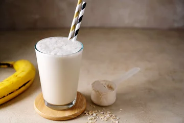 Zelfklevend Fotobehang Protein powder, shake drink, banana protein fitness drink, copy space © Inga