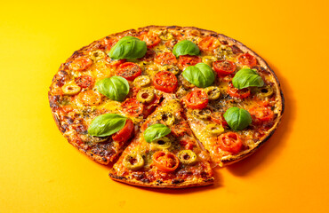 Pizza Margherita with basil tomato and mozzarella, on orange background.