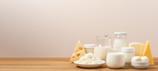 Variation of organic dairy products on wooden table. Farm cheeses, milk, cottage cheese, yogurts on...