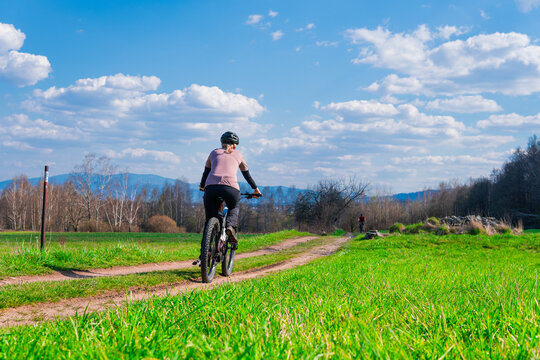 woman on an electric mountain bike on a dirt path in the mountains