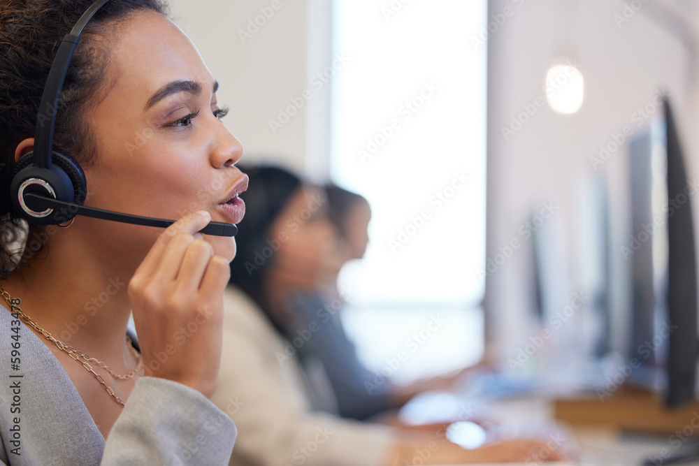Poster shes equipped with all the knowledge to make big sales. shot of a young call centre agent working in