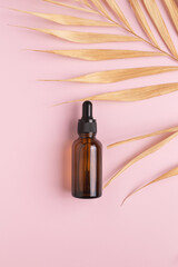Naklejka premium Cosmetic bottle with body and face oil and palm leaf, summer natural cosmetics, serum, facial oil, tropical concept.