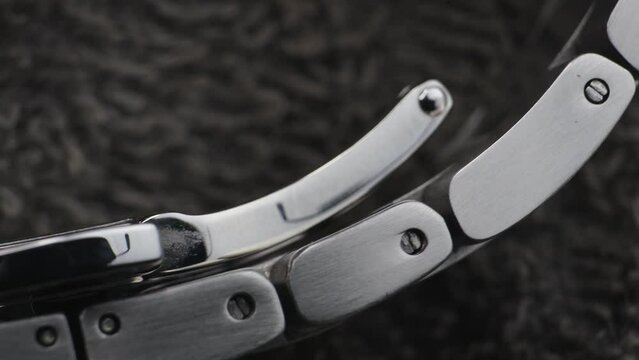 Macro close up of a steel metal professional watch strap in details 
