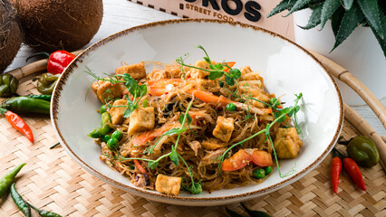 Glass noodles with chicken, carrots, onions, sweet peppers, green peas and microgreens.