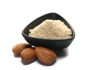 Almonds ground pile in bowl and whole shell isolated on white  