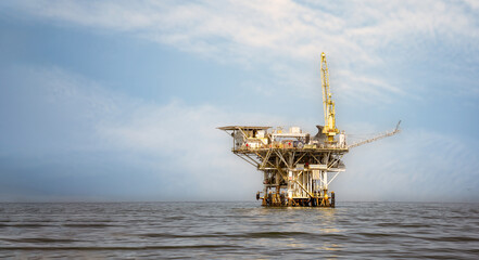 Offshore Oil platform at sea for gas and oil with tower, crane and other industrial equipment for drilling at sea for energy exploration California