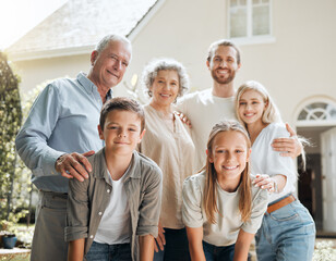 Keep your family close. Shot of a multi-generational family standing together outside.