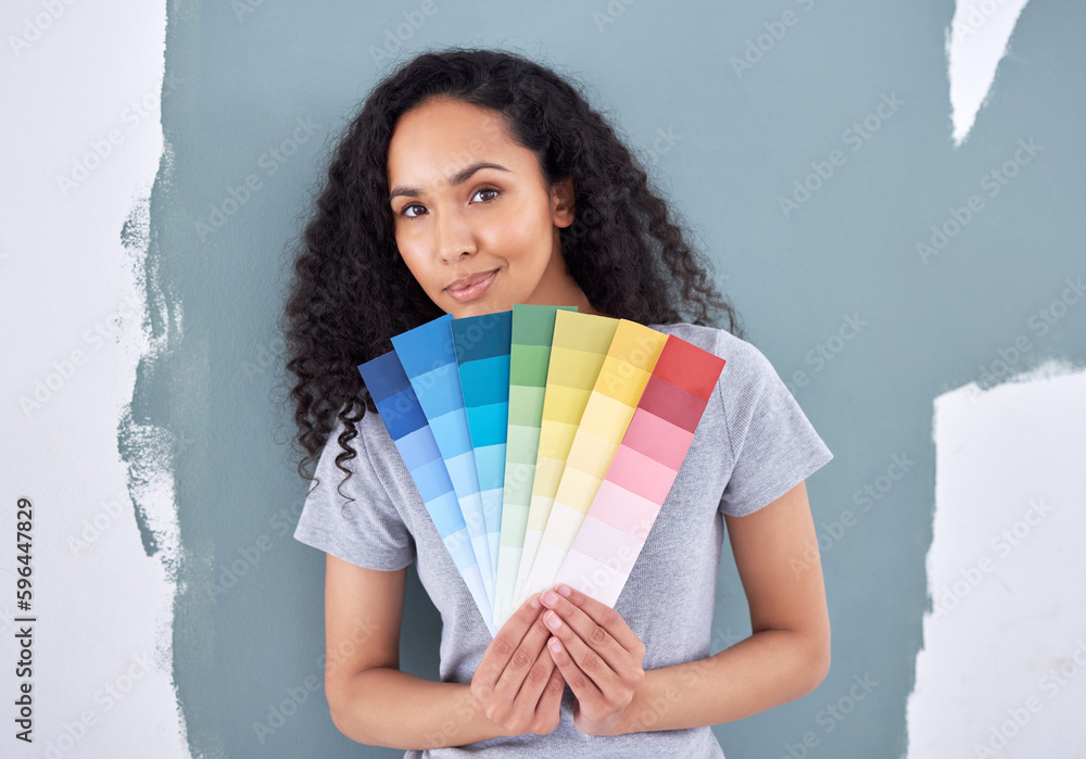 Poster what color can i add to compliment this one. shot of a woman holding up color swatches while standin