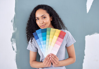 What color can I add to compliment this one. Shot of a woman holding up color swatches while...