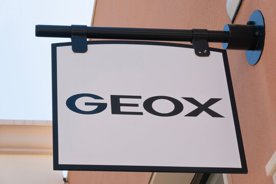 Orihuela Costa, Alicante, Spain - April 12, 2023: Geox logo sign on store wall. Geox is Italian brand of shoe and clothing manufactured with waterproof and breathable fabrics
