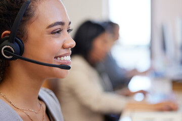 Friendly is the approach we always take. Closeup shot of a young call centre agent working in an...